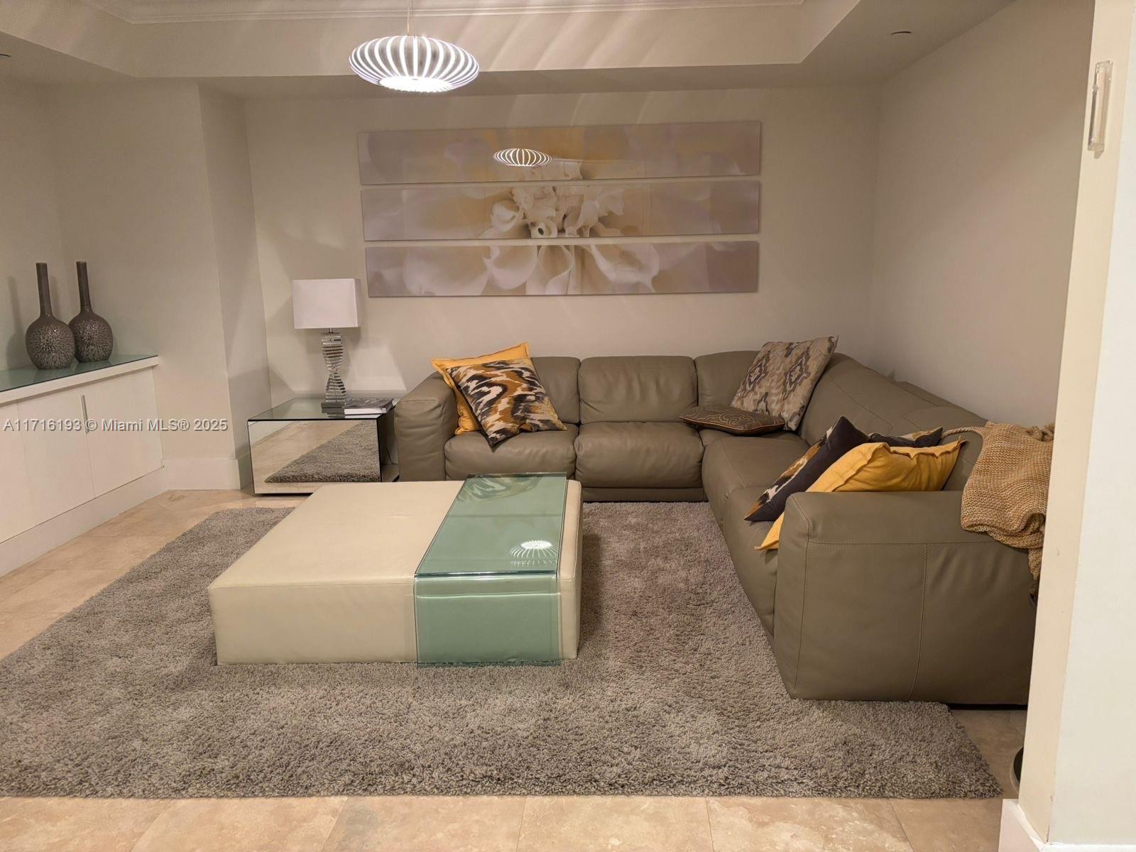 20201 East Country Club Drive, Unit 409 Aventura, FL 33180 - Photo 8 of 12 a living room with furniture and a rug