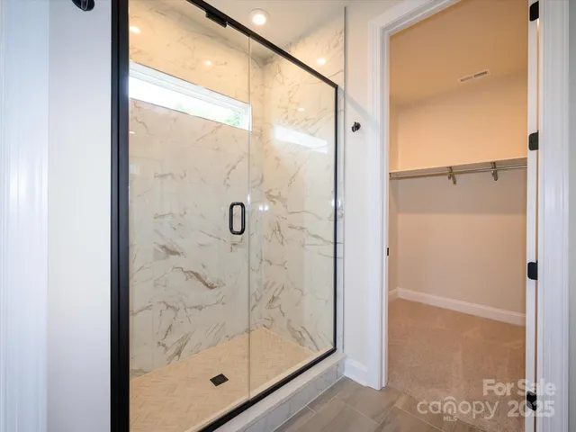 a bathroom with a glass shower door