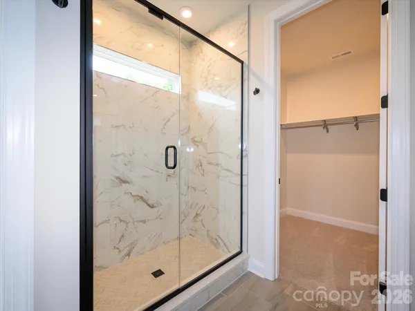 a bathroom with a glass shower door