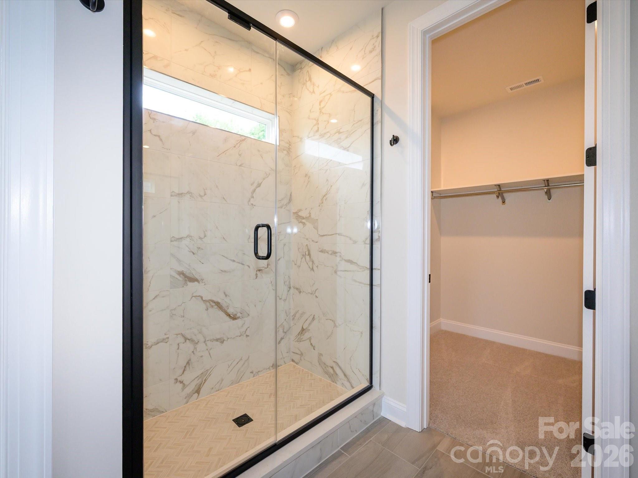 403 Old Town Vlg Road Waxhaw, NC 28173 - Photo 15 of 23 a bathroom with a glass shower door