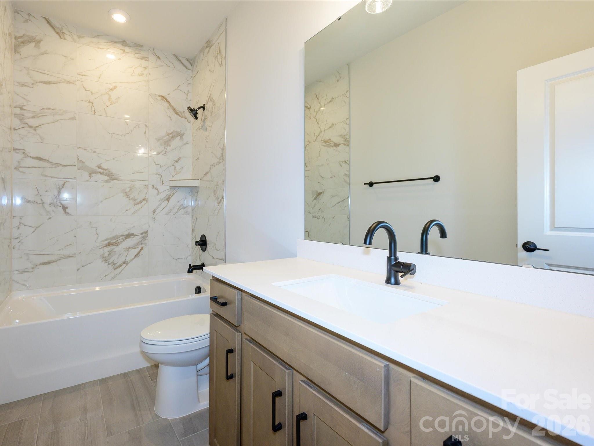 403 Old Town Vlg Road Waxhaw, NC 28173 - Photo 18 of 23 a bathroom with a sink a toilet and a bathtub
