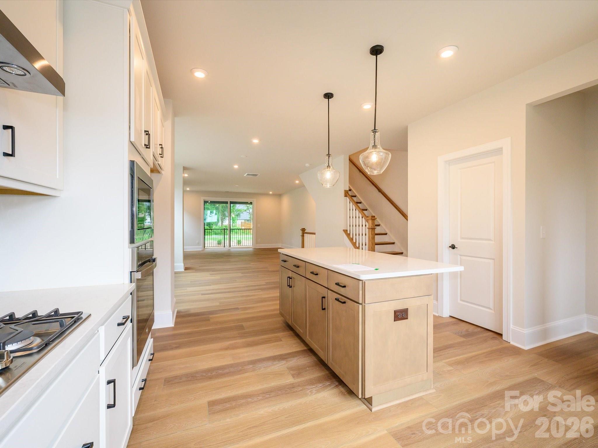 403 Old Town Vlg Road Waxhaw, NC 28173 - Photo 2 of 23 a large white kitchen with sink a stove and a wooden floors