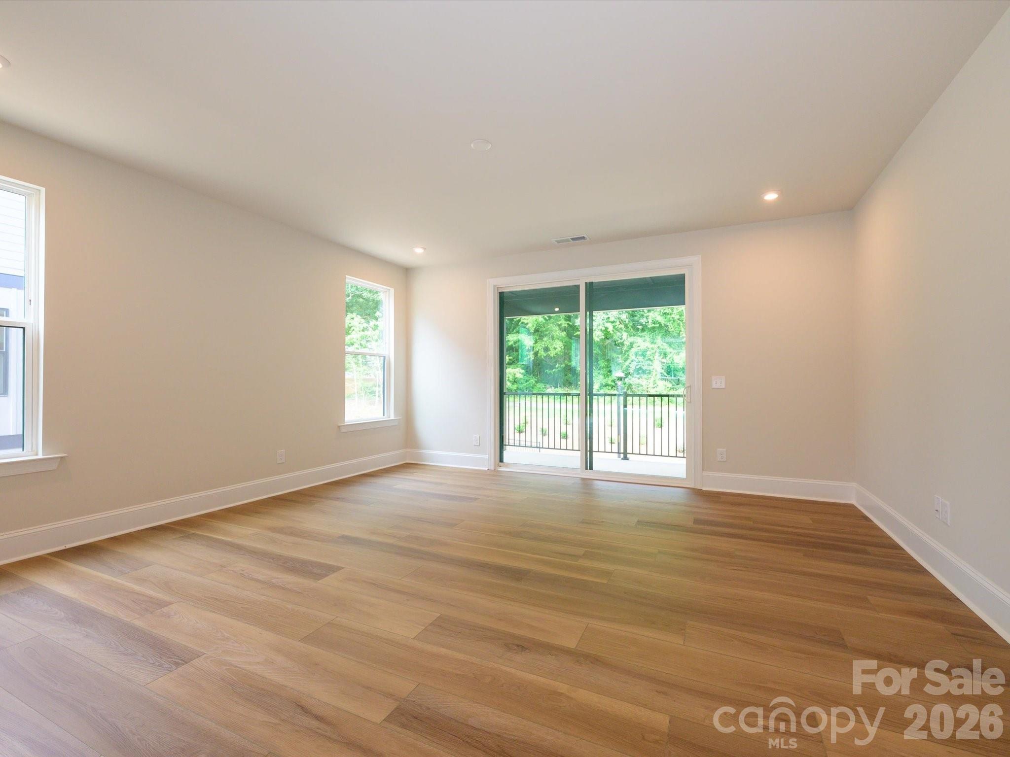 403 Old Town Vlg Road Waxhaw, NC 28173 - Photo 9 of 23 a view of an empty room with wooden floor and a window