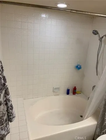 a bedroom with a bed chair and table