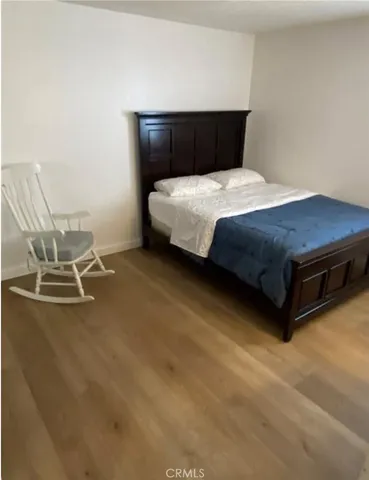 a bedroom with a bed and a lamp