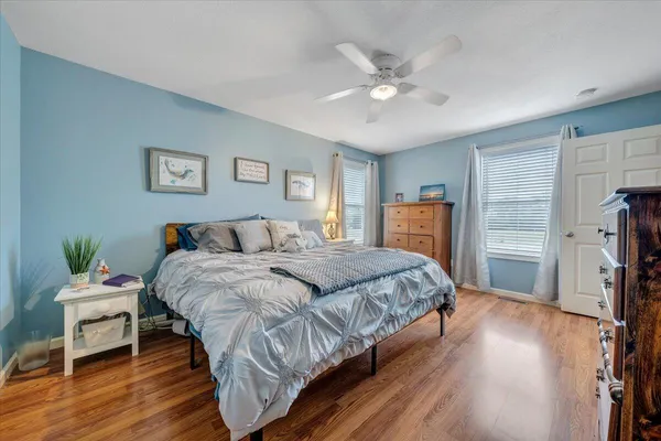 a bedroom with a large bed and a chandelier