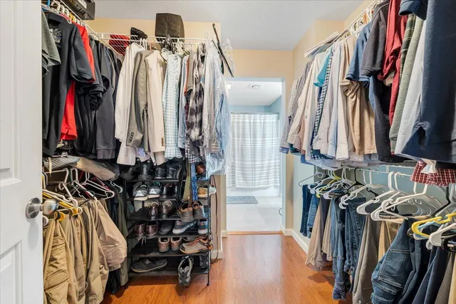 a view of walk in closet with clothes