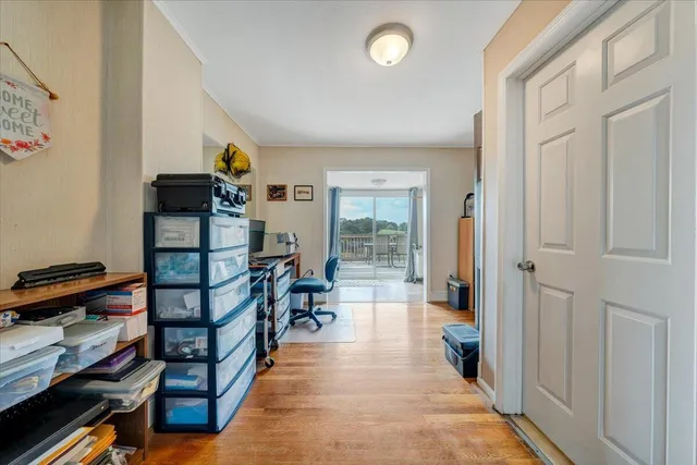 a hallway with wooden floor and furniture