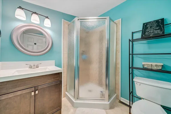 a bathroom with a toilet a sink and a shower