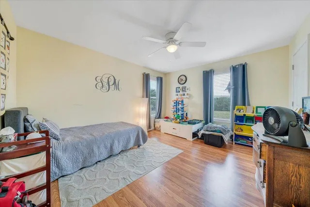 a bedroom with a bed and wooden floor