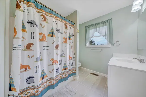a bathroom with a sink and a shower curtain