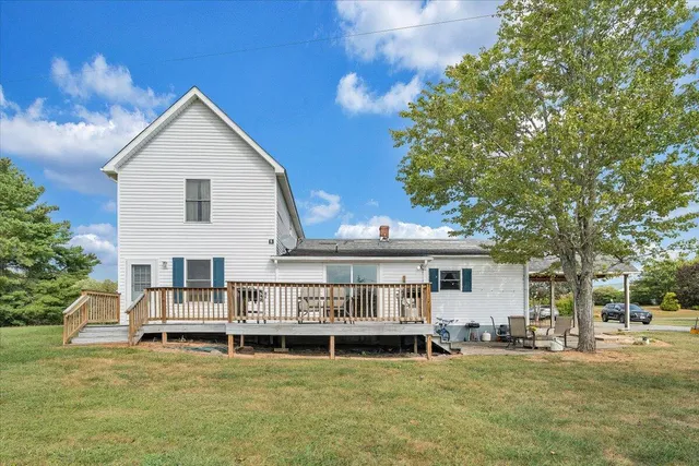 a view of a house with swimming pool and sitting area