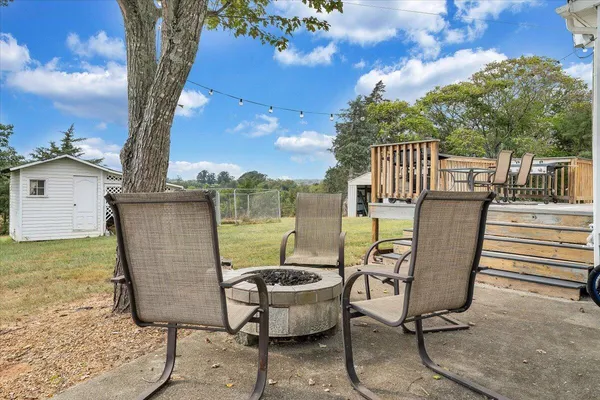 a view of a chairs and table in the patio