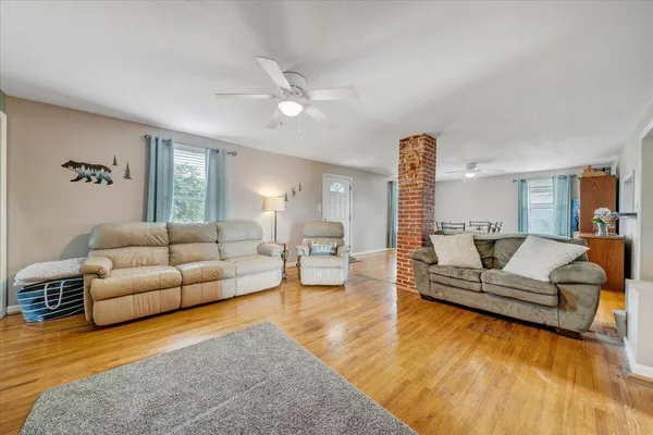 a living room with furniture and wooden floor