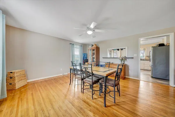 a dining room with furniture and wooden floor