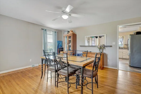 a view of a dining room with furniture and wooden floor