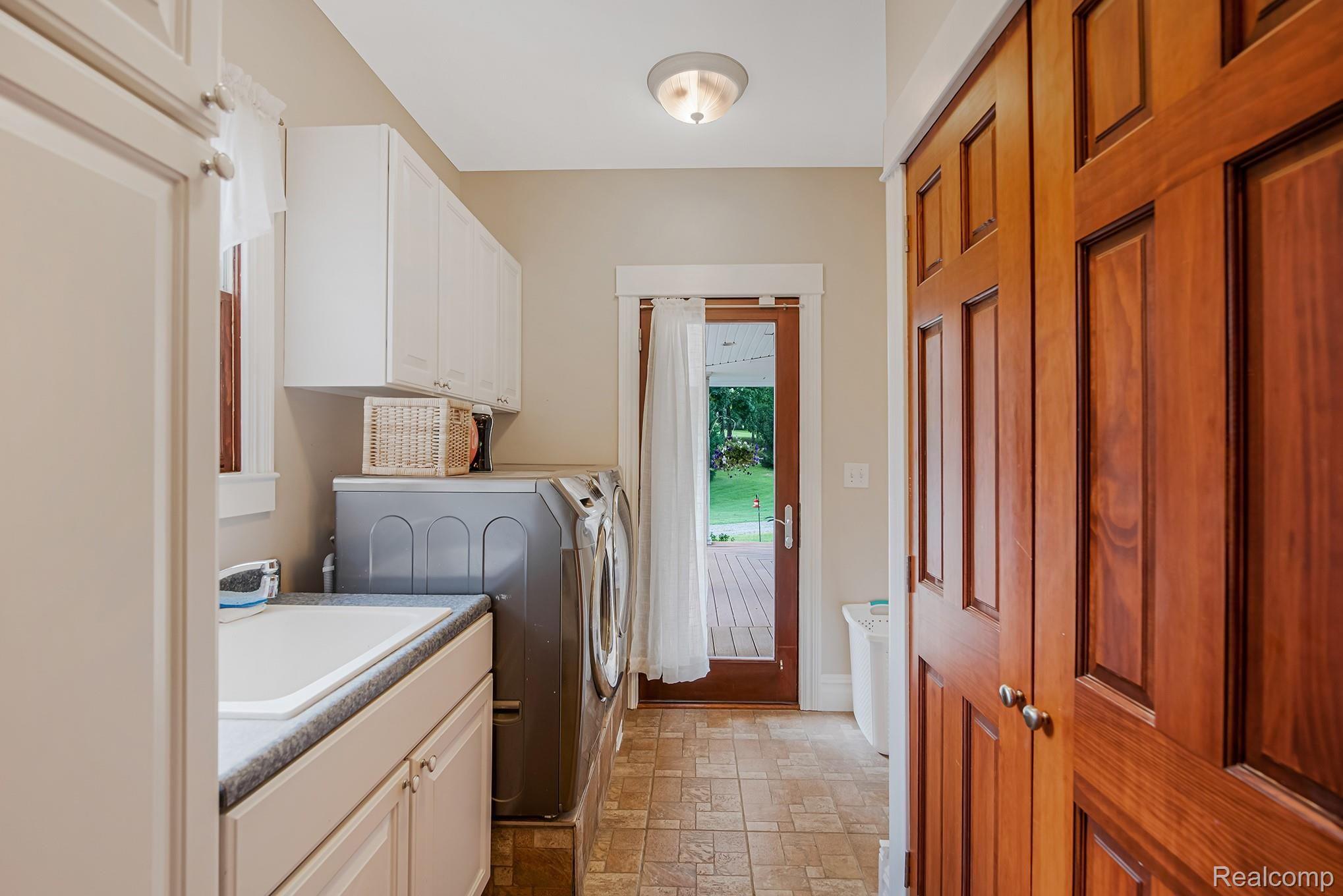 5412 Vines Road Howell, MI 48843 - Photo 22 of 47 1st floor laundry with washtub sink and door to covered porch