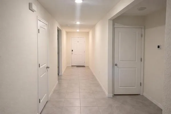 a view of a hallway to rooms