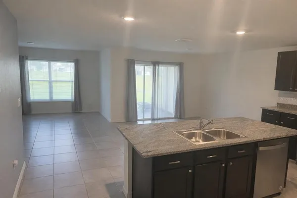 a kitchen with a sink a counter top space and cabinets