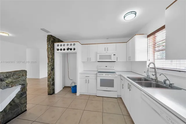 a kitchen with a stove sink and refrigerator