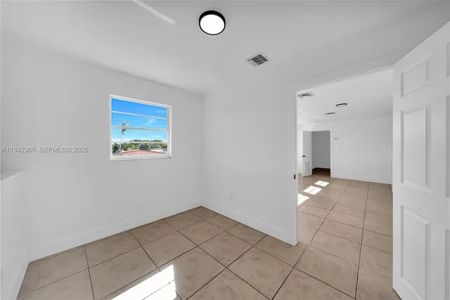 a view of a livingroom with wooden floor and a window