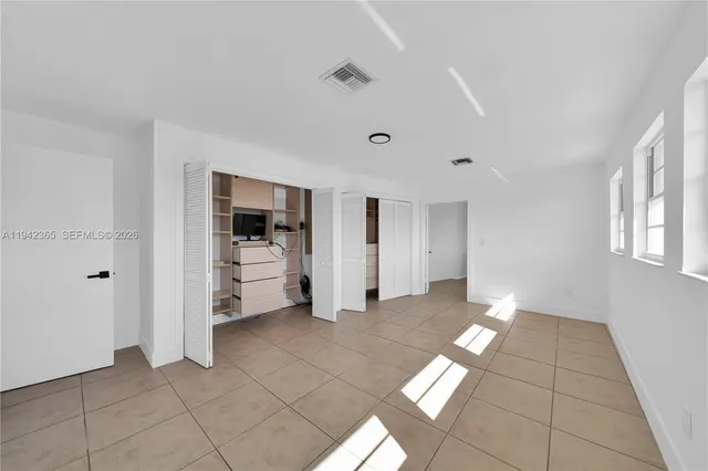 a view of a big room with windows and cabinet