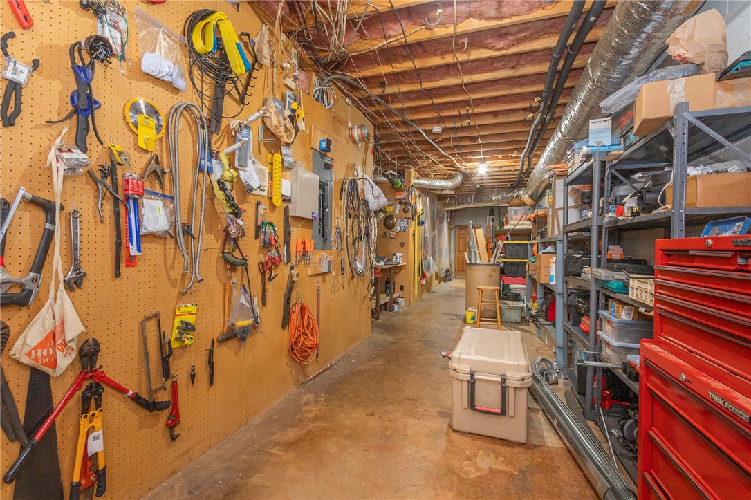 911 State Rd S-4-203 Belton, SC 29627 - Photo 29 of 49 A well-organized utility area with extensive shelving and pegboard storage for tools.