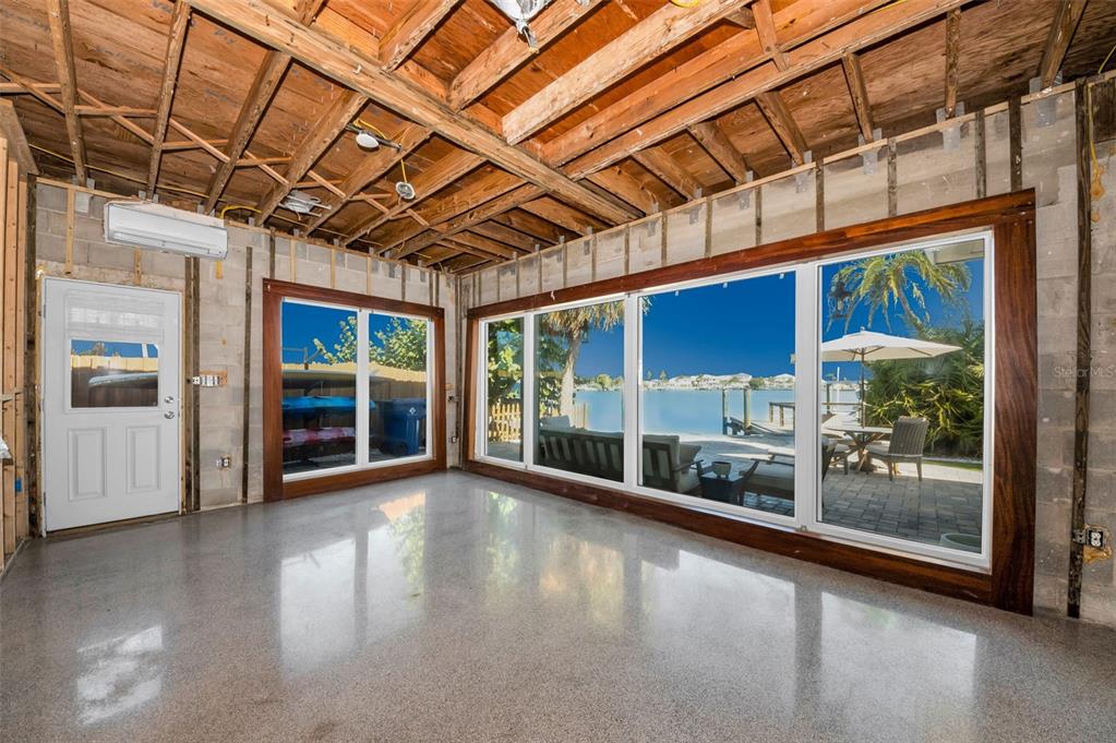 16101 Redington Drive Redington Beach, FL 33708 - Photo 26 of 43 a view of an empty room with wooden floor and a window