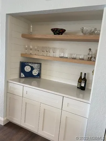 a view of white cabinets and a wooden floor
