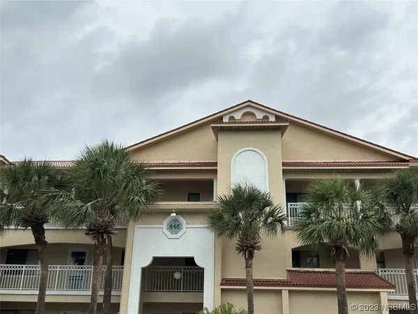 a front view of a house with plants