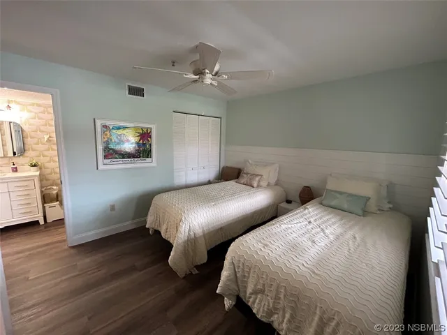 a bedroom with two beds and a chandelier