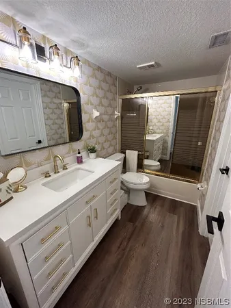 a bathroom with a double vanity sink mirror and toilet