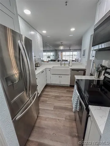 a kitchen with a sink stainless steel appliances and cabinets