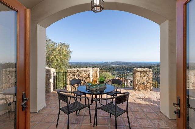 a view of a chairs and table in a balcony