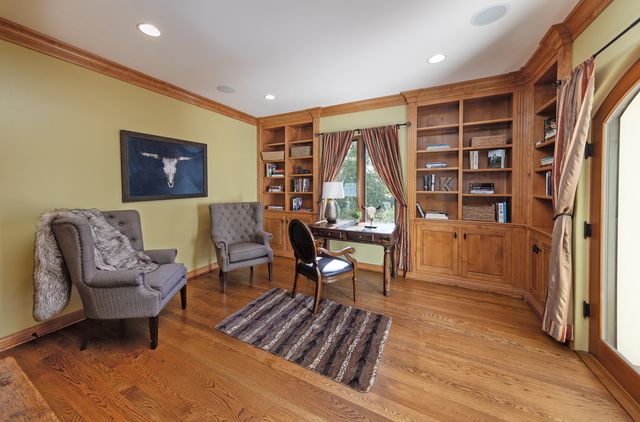 a living room with furniture a rug and a large window