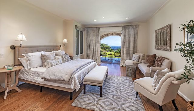 a spacious bedroom with a bed a couch and a window