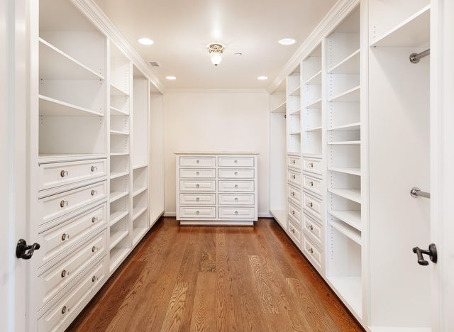 a view of walk in closet with empty racks