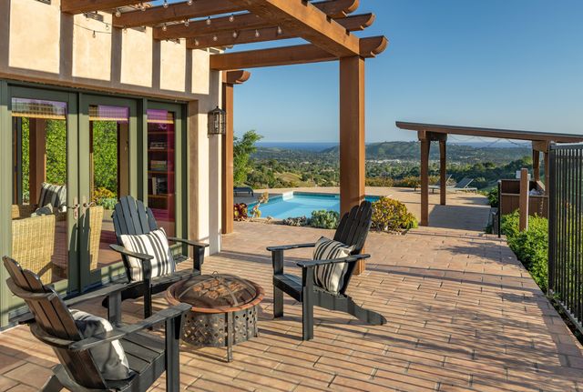 a view of a patio with table and chairs and potted plants