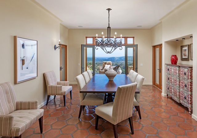 a view of a dining room with furniture wooden floor and a chandelier