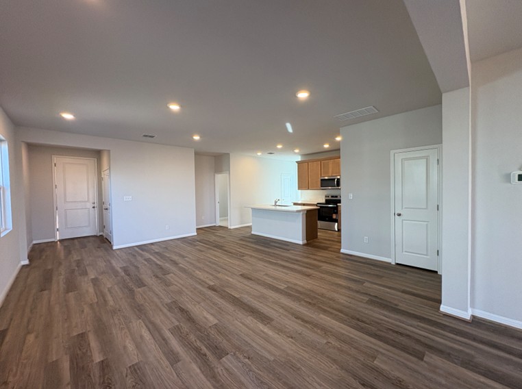 111 Elm Br Trail Taylor, TX 76574 - Photo 7 of 26 From Family Room to Open Concept Kitchen