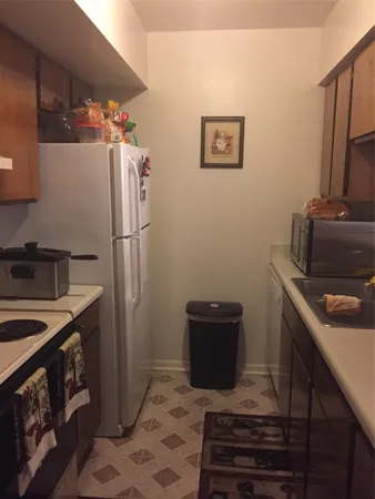 a kitchen with a sink stove and refrigerator