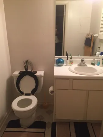 a bathroom with a toilet sink and mirror