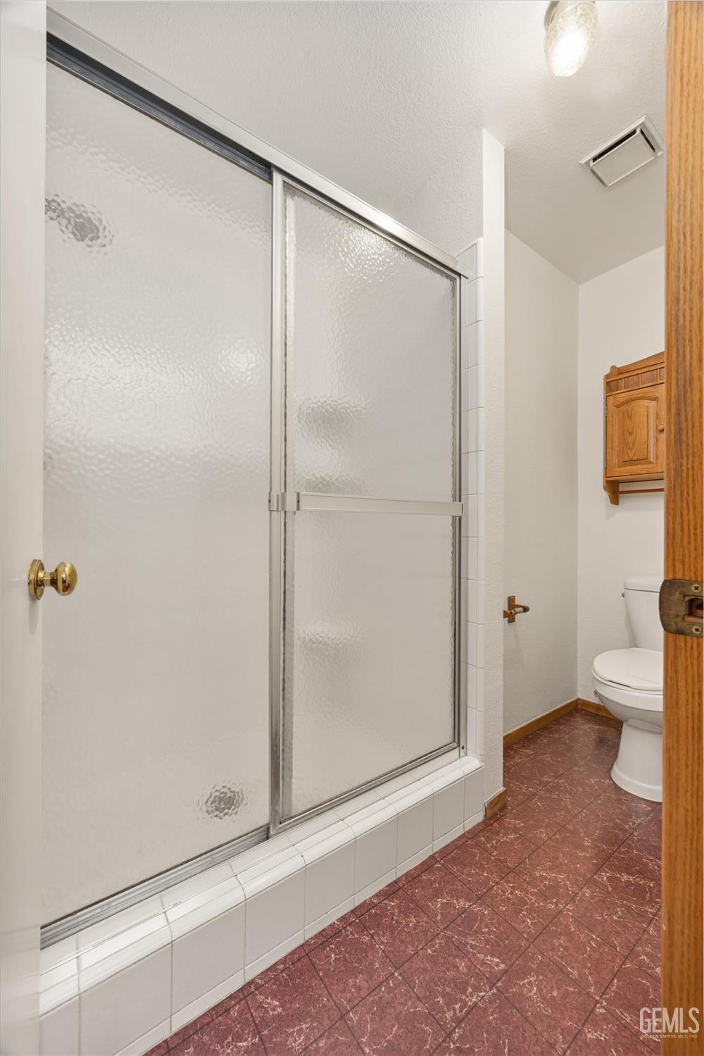 Undisclosed Address Bakersfield, CA 93307 - Photo 14 of 26 a bathroom with a shower and a toilet
