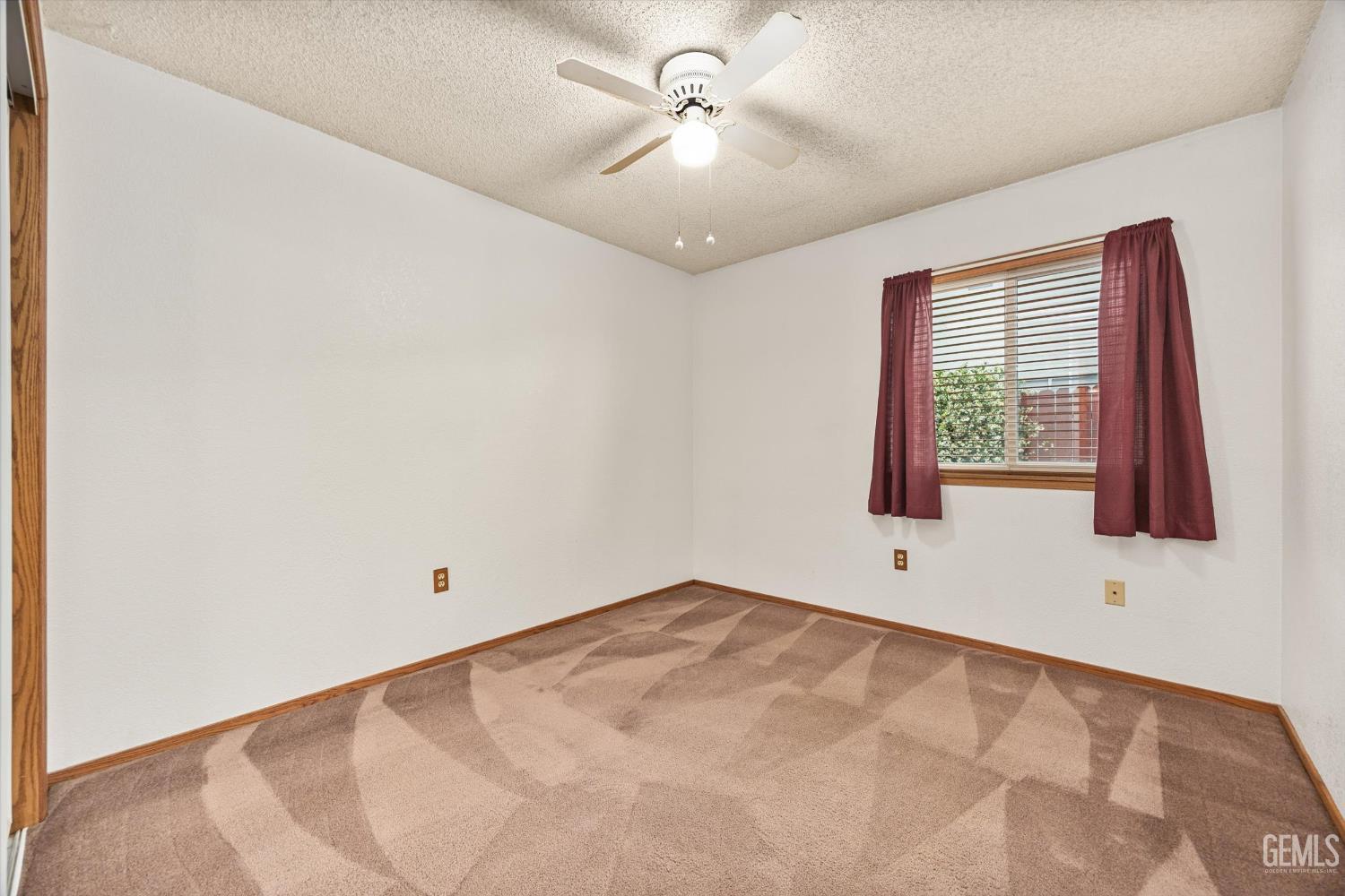 Undisclosed Address Bakersfield, CA 93307 - Photo 16 of 26 an empty room with windows and fan