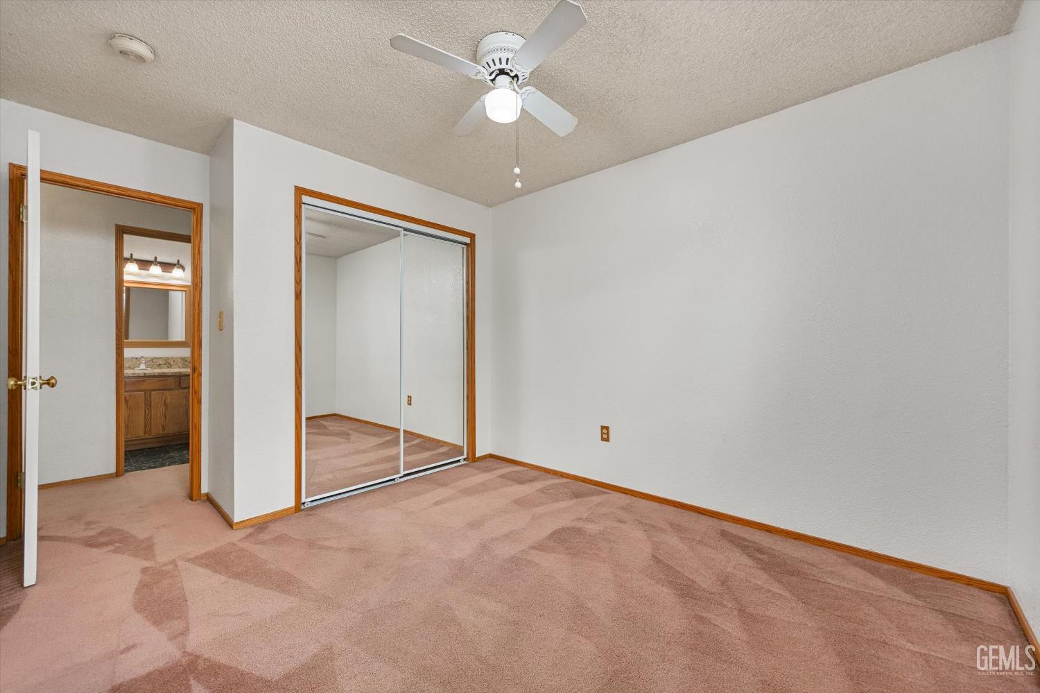 Undisclosed Address Bakersfield, CA 93307 - Photo 17 of 26 an empty room with closet and a ceiling fan