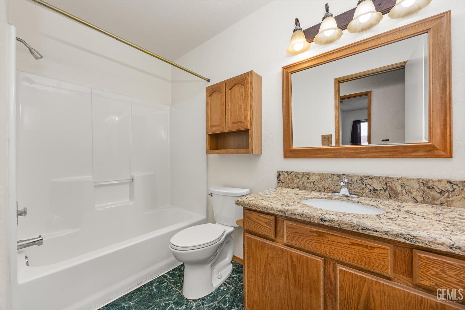 Undisclosed Address Bakersfield, CA 93307 - Photo 18 of 26 a bathroom with a granite countertop sink toilet and shower