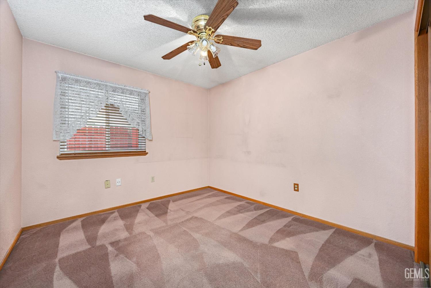 Undisclosed Address Bakersfield, CA 93307 - Photo 19 of 26 an empty room with a window and a fan