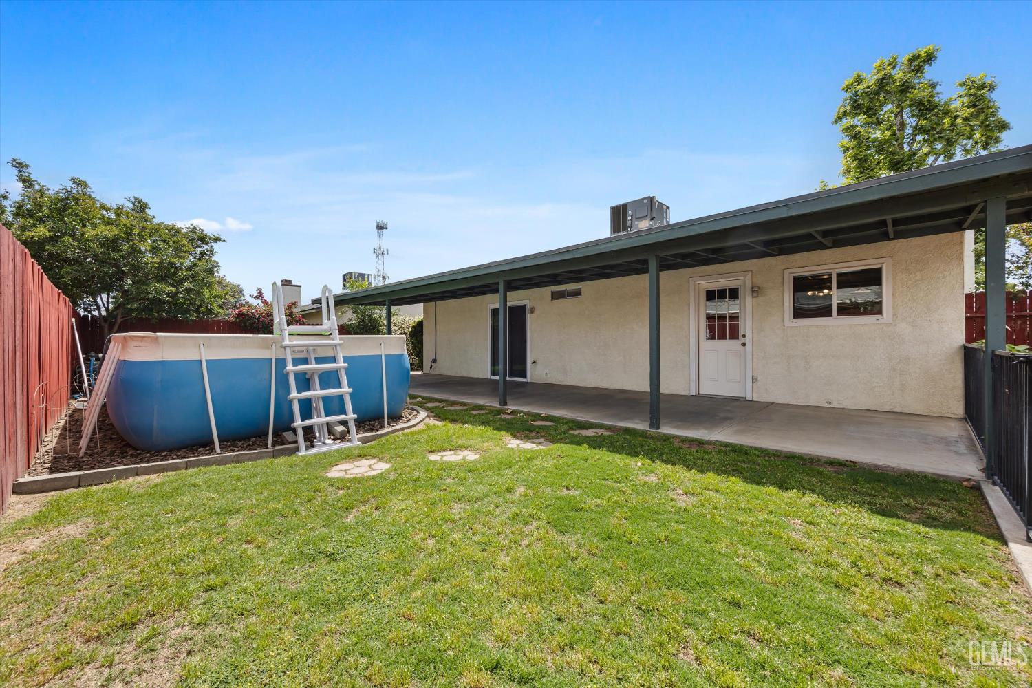 Undisclosed Address Bakersfield, CA 93307 - Photo 25 of 26 a backyard of a house with wooden floor and fence