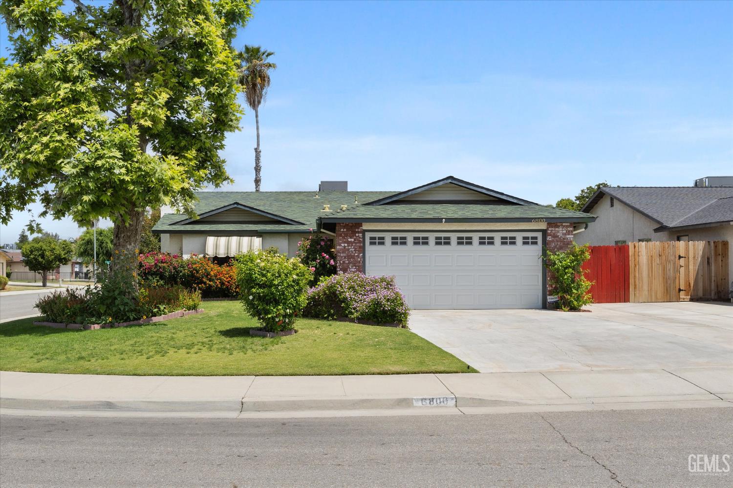 Undisclosed Address Bakersfield, CA 93307 - Photo 3 of 26 a front view of a house with a yard and garage