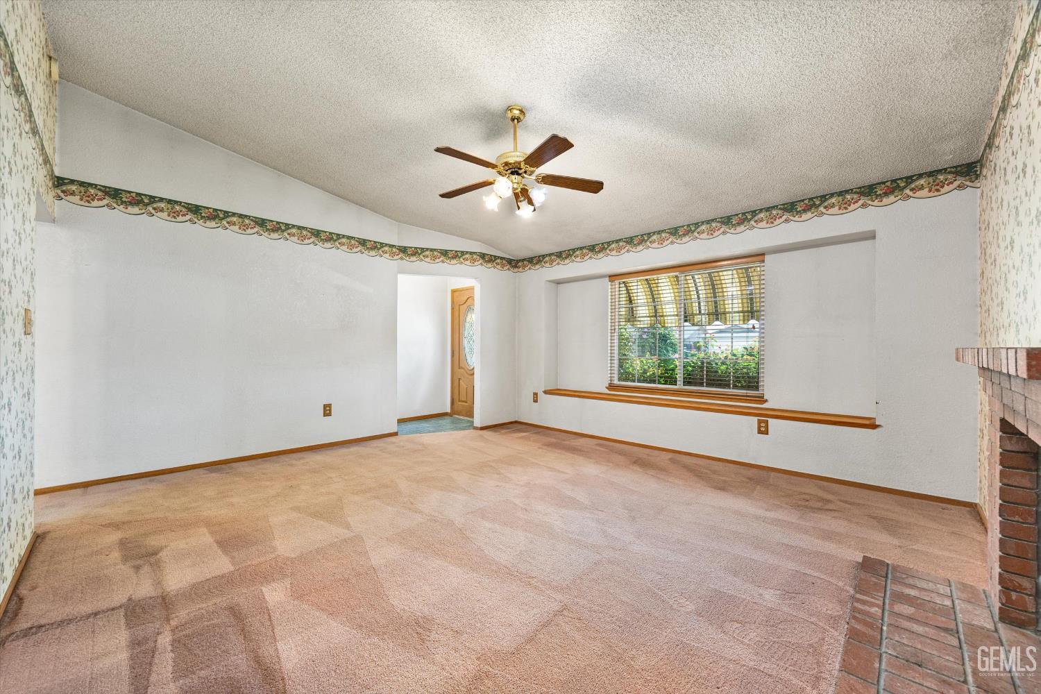 Undisclosed Address Bakersfield, CA 93307 - Photo 5 of 26 a view of a livingroom with a ceiling fan and window